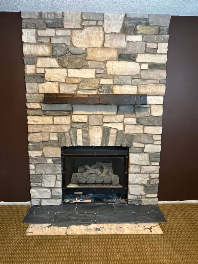 picture of a fireplace full of textured stonework