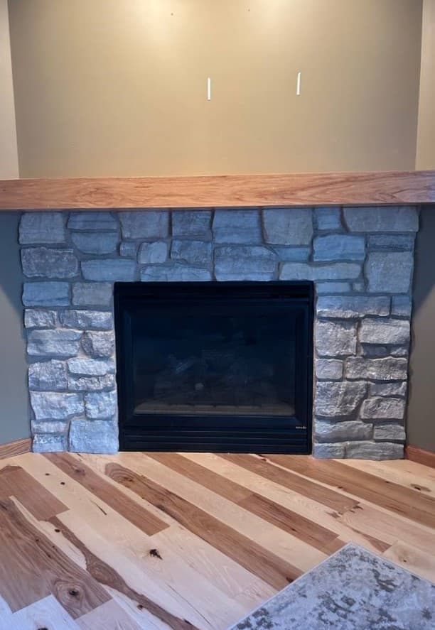 picture of a fireplace surrounded by stonework