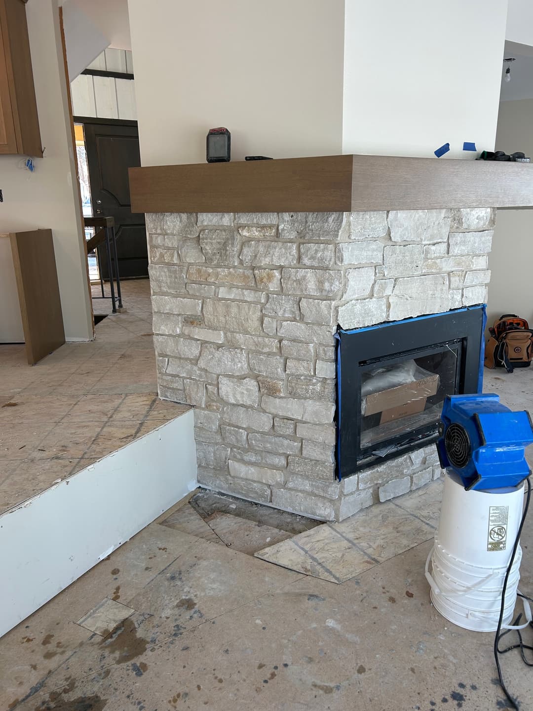 picture of a fireplace with beautiful light gray stonework of various sized stones